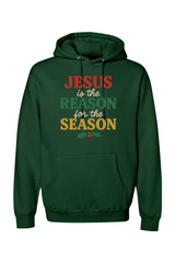 Dark green Christmas hoodie with 'Jesus is the Reason for the Season' text in red, green, and yellow color and a holly design underneath Jesus Christian holiday long sleeve hooded sweatshirt